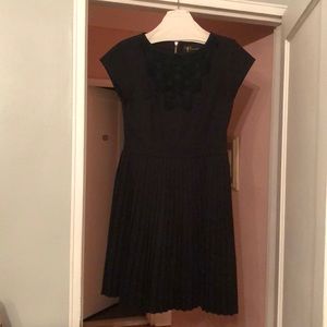 Black dress with pleated skirt